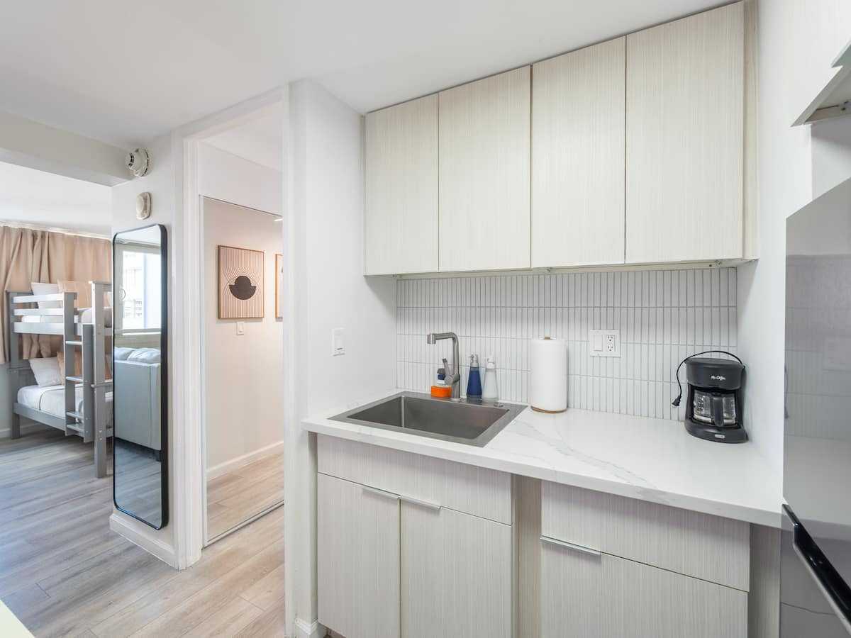 Kitchen appliances and counter beside the hallway
