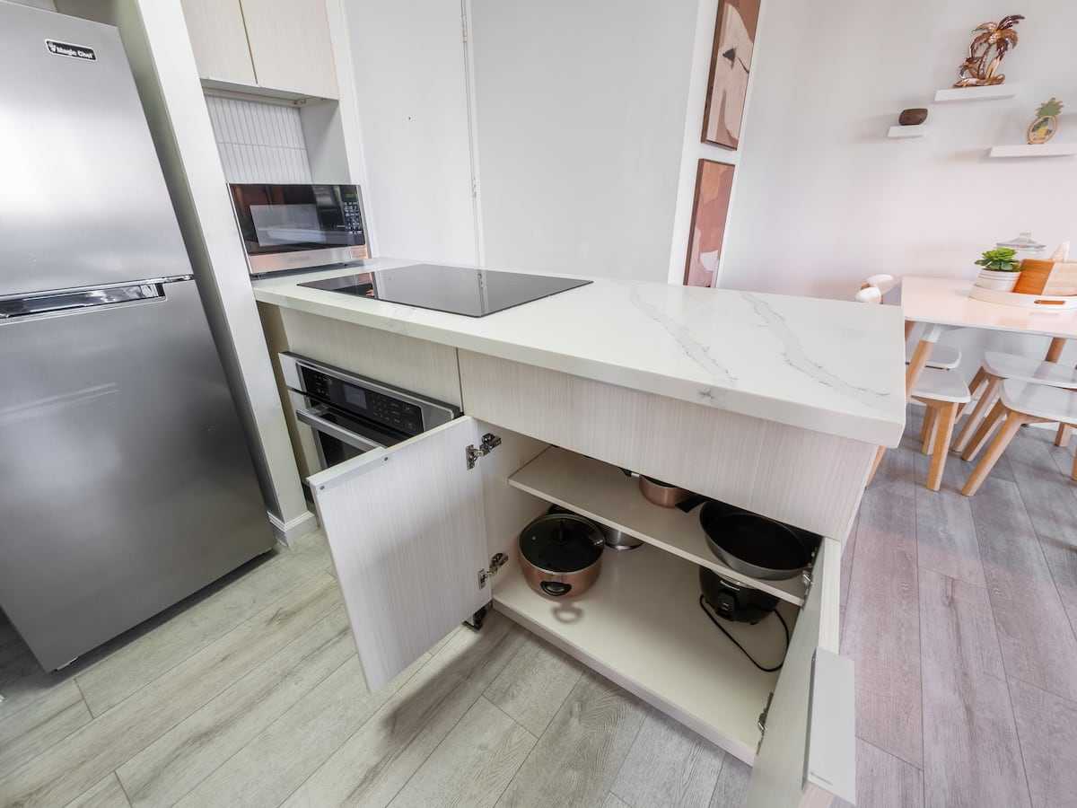Open kitchen storage below the peninsula