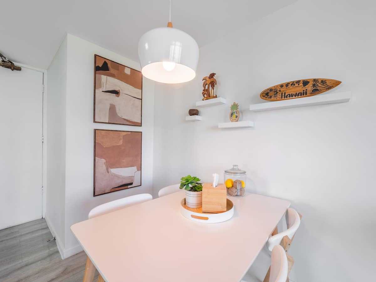 Round dining table beneath framed wall art