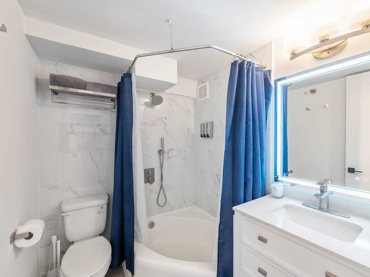 Bathroom with shower, toilet, and vanity