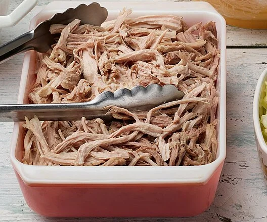 Shredded kālua pork in a serving dish.